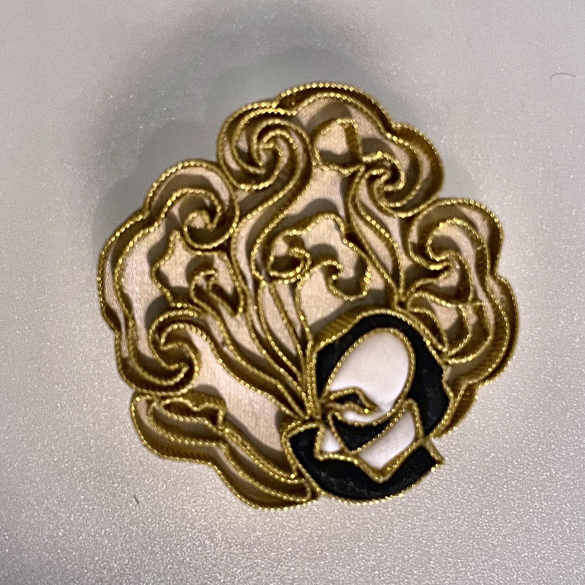 Shakespeare lucky cloud brooch: pankou silk knots couched in gold thread, with the portrait silhouette at the centre