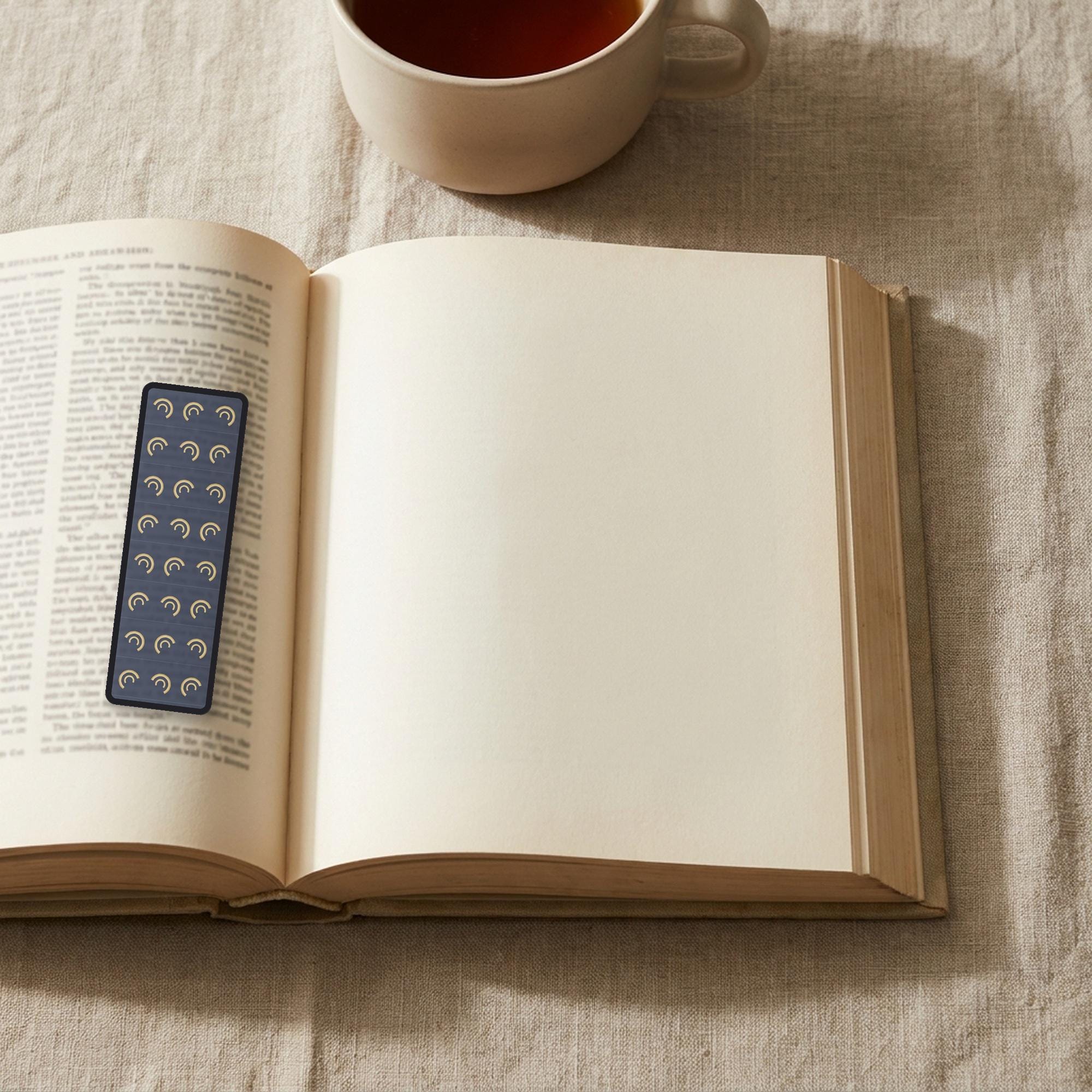 The Wine-Dark Sea Odyssey bookmark lying on an open book, the page text visible through the sheer organza