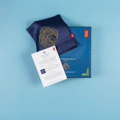 Folded navy silk scarf with the Othello card