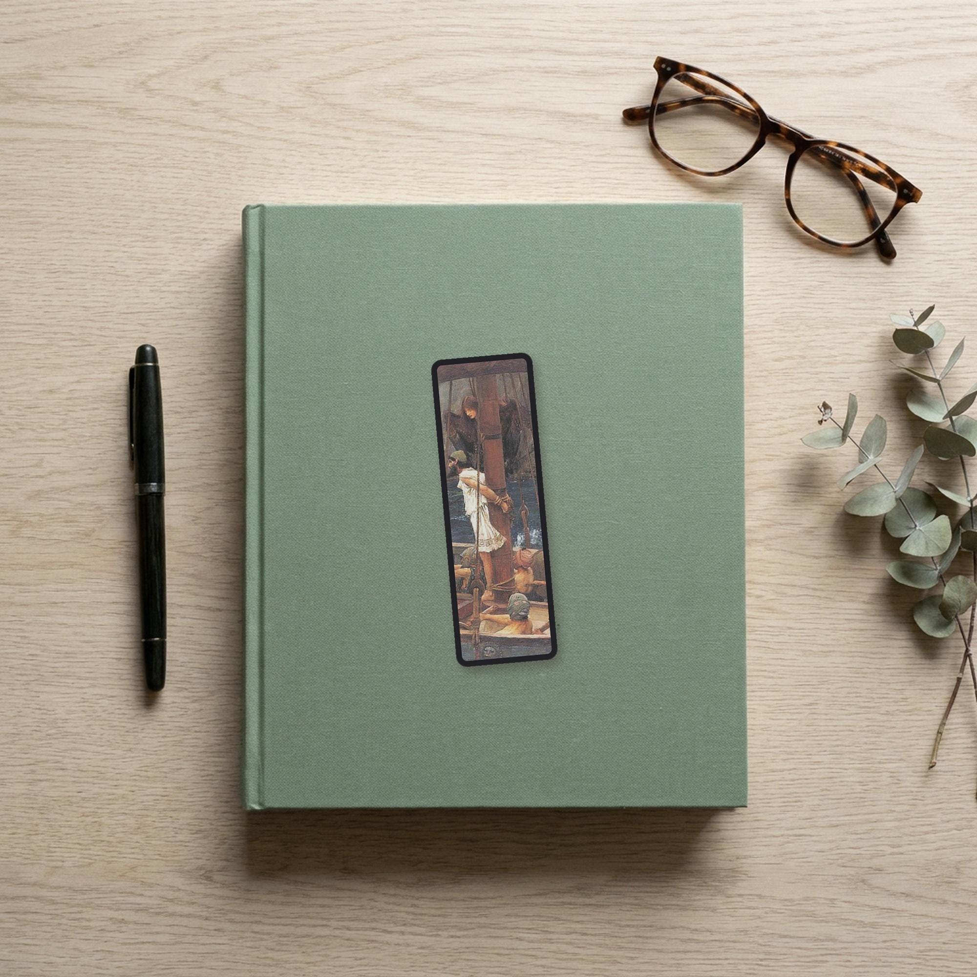 Bound to the Mast Odyssey bookmark flat lay on a desk with a book, pen and reading glasses