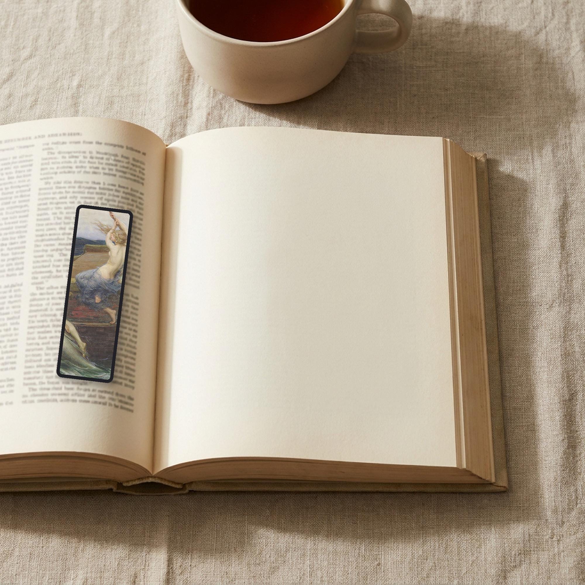 The Siren Climbs Aboard Odyssey bookmark lying on an open book, the page text visible through the sheer organza