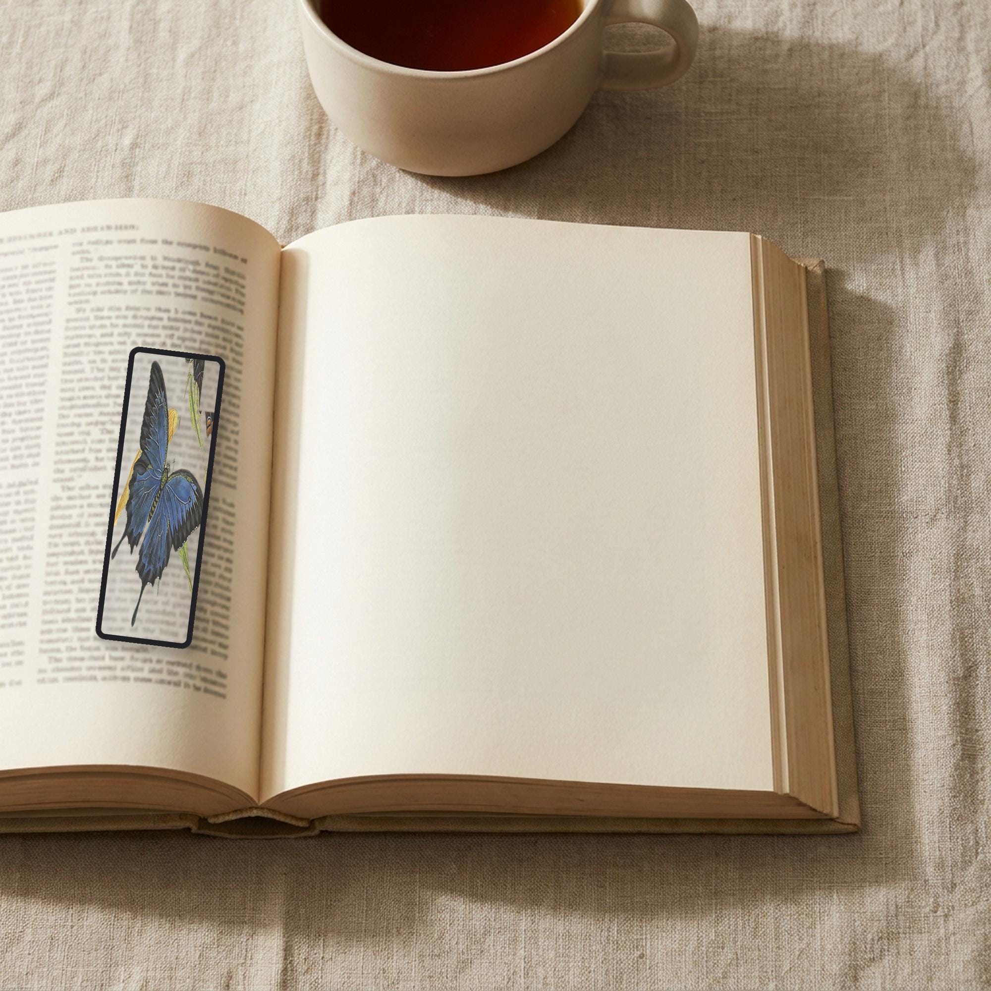 The Ulysses Butterfly Odyssey bookmark lying on an open book, the page text visible through the sheer organza