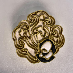 Shakespeare lucky cloud brooch: pankou silk knots couched in gold thread, with the portrait silhouette at the centre