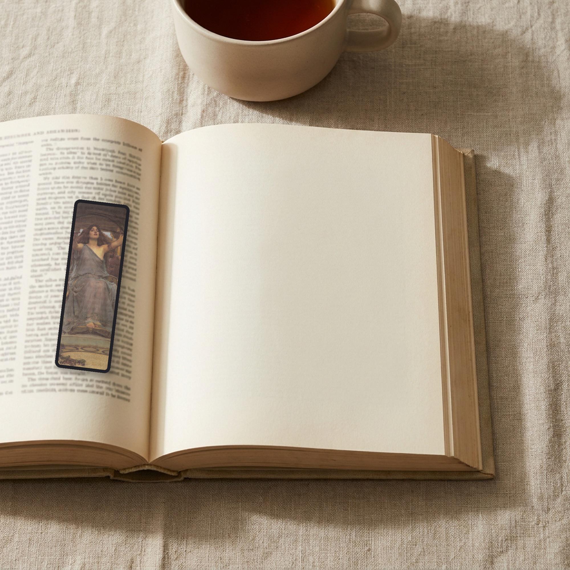 Circe's Cup Odyssey bookmark lying on an open book, the page text visible through the sheer organza