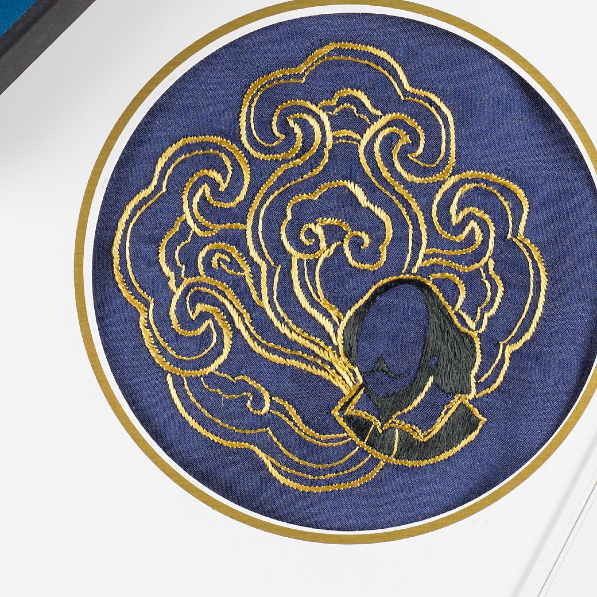 Close-up of the hand-embroidered gold cloud roundel with the Shakespeare portrait