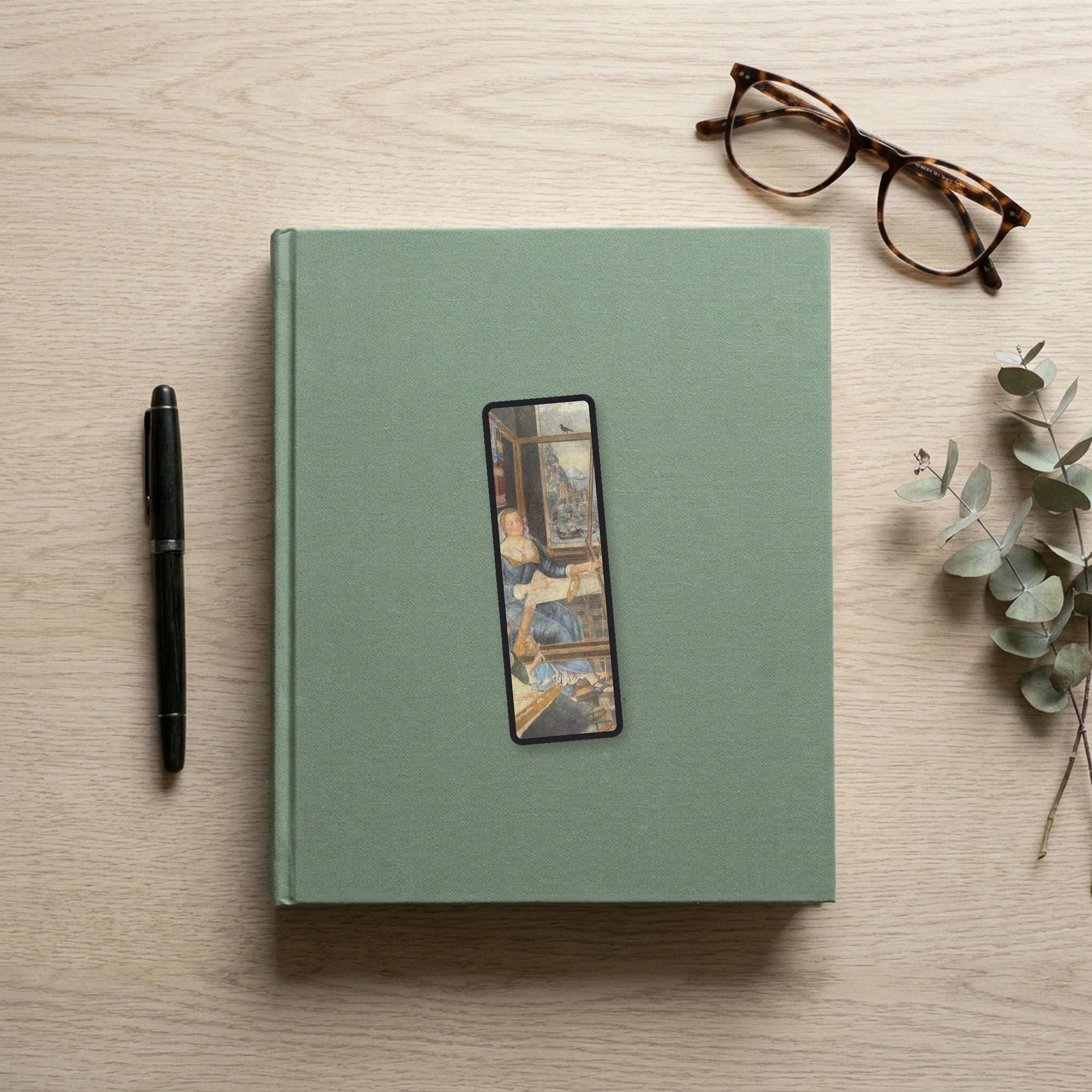 Penelope at Her Loom Odyssey bookmark flat lay on a desk with a book, pen and reading glasses